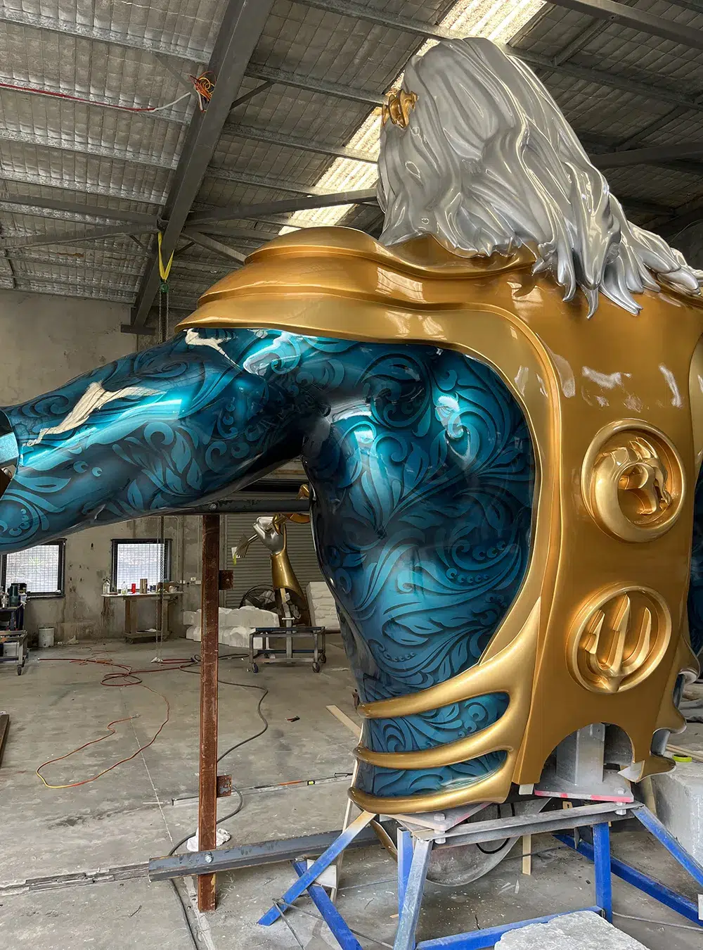 Artists working on the finishing touches of the Atlantean figure.