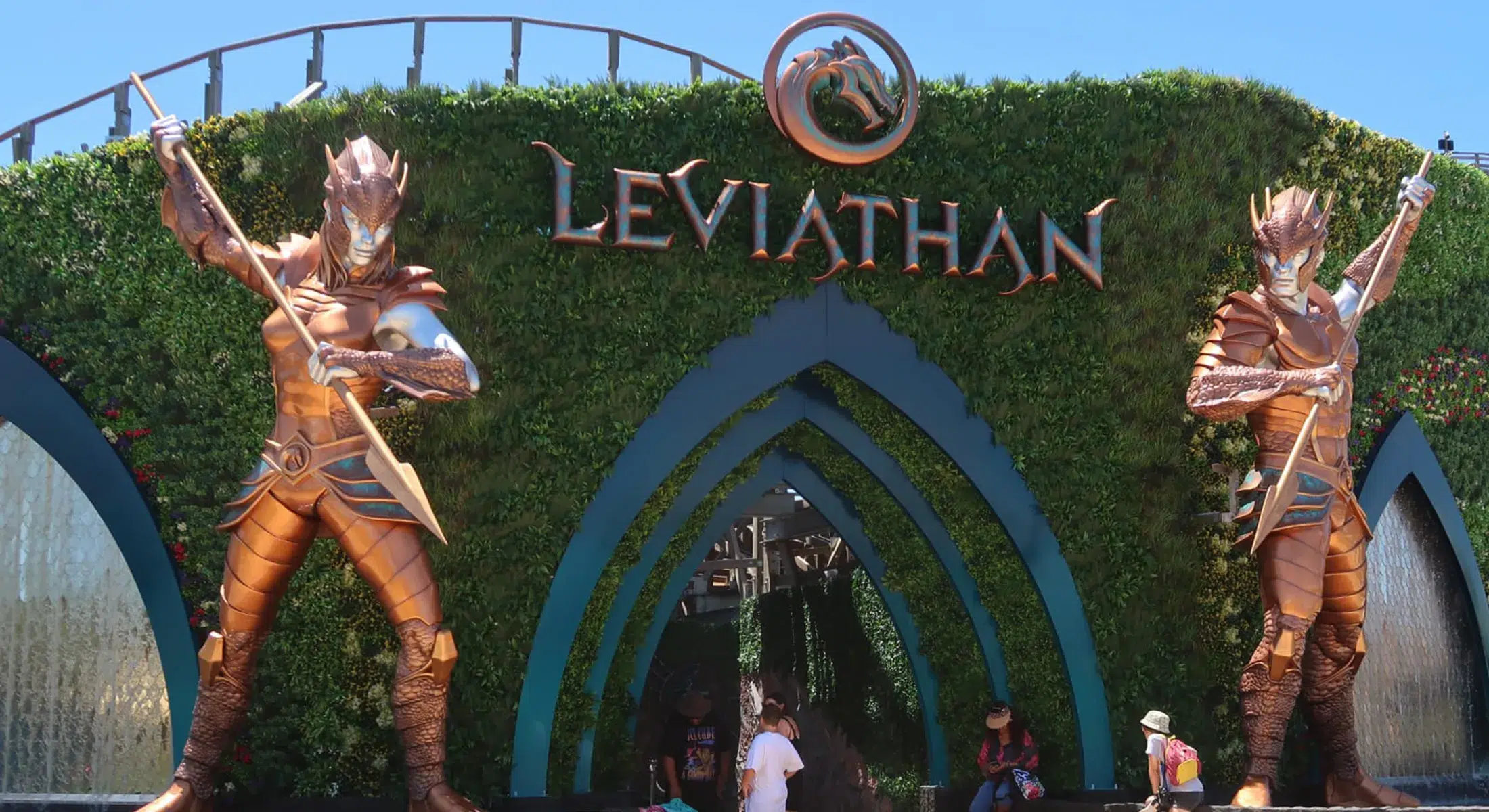 Golden armored statues guarding the entrance of Leviathan ride, designed by Sculpt Studios."